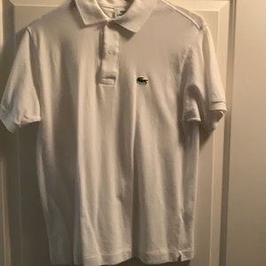 Lacoste polo in white size 4. 1 small stain on right shoulder, 1 on left breast